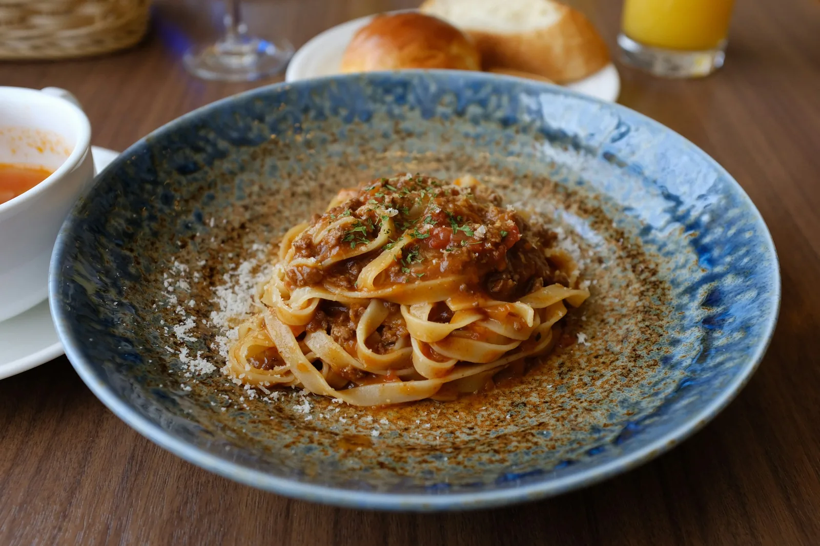 Cooked tagliatelle on a blue plate (Bologna)