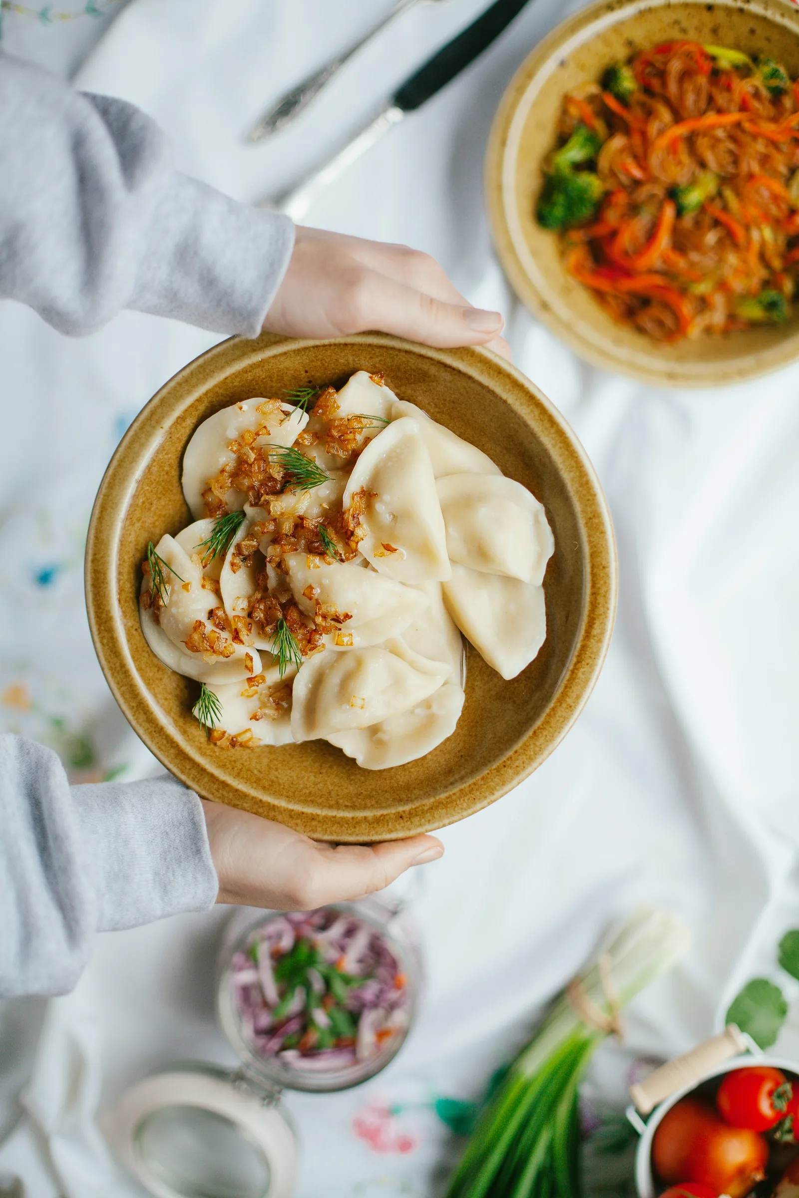 Pierogi with sour cream in a bowl (Warsaw)